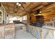 Rustic outdoor kitchen featuring a grill, island, ceiling fans, and spa at 13199 Ash St, Thornton, CO 80241