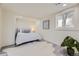 Cozy bedroom with a plush bed, neutral decor, and a window offering natural light at 3275 S Decatur St, Denver, CO 80236
