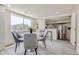Dining area with a marble-top table, stylish chairs, and an open view into the kitchen at 3275 S Decatur St, Denver, CO 80236