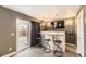 Stylish bar area featuring modern seating, a built-in bar, and a sliding glass door to the outdoors at 11591 S Maiden Hair Way, Parker, CO 80134