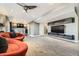 Open basement with bar area, comfortable seating, and a large television for entertaining at 11591 S Maiden Hair Way, Parker, CO 80134
