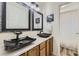 Modern bathroom with marble countertops, dual sinks, and stylish black accents at 11591 S Maiden Hair Way, Parker, CO 80134