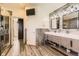 Modern main bathroom boasting a double vanity, stylish mirrors, and a glass-enclosed shower at 11591 S Maiden Hair Way, Parker, CO 80134