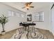 Bright office features a ceiling fan, modern black desk, and ample natural light at 11591 S Maiden Hair Way, Parker, CO 80134