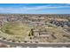 Community aerial view features a pool, park, playground, green spaces, and homes under a blue sky at 17382 Bluetrail Ave, Parker, CO 80134