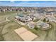 Aerial view of a community park with a playground, pool, and sand volleyball court at 17382 Bluetrail Ave, Parker, CO 80134