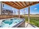 Backyard features a hot tub and a covered patio area, perfect for relaxing and entertaining at 17382 Bluetrail Ave, Parker, CO 80134