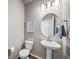 Well-lit powder room with pedestal sink, modern fixtures, and stylish wall decor at 17382 Bluetrail Ave, Parker, CO 80134