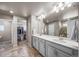 Bright bathroom with double vanity, tile flooring, and walk-in closet at 17382 Bluetrail Ave, Parker, CO 80134