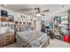 Comfortable bedroom featuring a striped bed, a wooden dresser and shelves at 17382 Bluetrail Ave, Parker, CO 80134