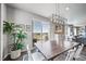 Bright dining room features a modern chandelier and sliding glass doors leading to the outdoor deck at 17382 Bluetrail Ave, Parker, CO 80134