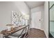 Entryway with wood floors, a decorative mirror, and a lamp on a console table at 17382 Bluetrail Ave, Parker, CO 80134