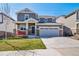 Beautiful two-story home with a well-manicured lawn, stone accents, and attached garage at 17382 Bluetrail Ave, Parker, CO 80134