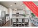 Beautiful kitchen featuring a large island with seating, stainless steel appliances, and modern lighting fixtures at 17382 Bluetrail Ave, Parker, CO 80134
