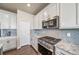 Kitchen boasting granite countertops, stainless steel appliances, and gray backsplash at 17382 Bluetrail Ave, Parker, CO 80134