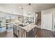 Open concept kitchen with large island, dining area, and access to the living room at 17382 Bluetrail Ave, Parker, CO 80134