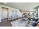 Living room showcasing an open floor plan and a gray accent wall at 17382 Bluetrail Ave, Parker, CO 80134