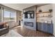 Stylish living room with electric fireplace, custom shelving, and large window at 17382 Bluetrail Ave, Parker, CO 80134