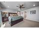 Spacious main bedroom with a ceiling fan and plush carpeting at 17382 Bluetrail Ave, Parker, CO 80134