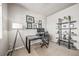 Home office featuring a modern desk, floating shelves with framed pictures, and a gray storage unit at 17382 Bluetrail Ave, Parker, CO 80134