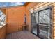Outdoor balcony area, featuring wood floors, a door, and a wood table at 2275 E 129Th Ave, Thornton, CO 80241