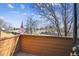 Scenic view from a wooden balcony, featuring lush trees, blue skies, and an American flag at 2275 E 129Th Ave, Thornton, CO 80241