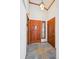 Warm and inviting foyer features tile flooring, wood door, and stylish light fixture at 2275 E 129Th Ave, Thornton, CO 80241