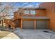 Two-car garage with driveway and staircase on the side of the house at 2275 E 129Th Ave, Thornton, CO 80241