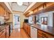 Well-lit kitchen with wooden cabinets, hardwood floors, and a breakfast bar overlooking the living space at 2275 E 129Th Ave, Thornton, CO 80241
