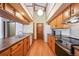 Spacious kitchen featuring hardwood floors, vaulted ceilings, and wood cabinetry at 2275 E 129Th Ave, Thornton, CO 80241