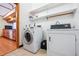 Laundry room with a washing machine and dryer next to the kitchen area at 2275 E 129Th Ave, Thornton, CO 80241