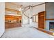 Open-concept living room featuring fireplace, built-in shelves, and open view to the kitchen at 2275 E 129Th Ave, Thornton, CO 80241