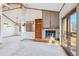 Open-concept living room featuring a fireplace, built-in shelving, and natural light at 2275 E 129Th Ave, Thornton, CO 80241