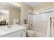 Bright bathroom features a tub shower, white tile, and vanity with a sink and a mirror at 19281 E Hinsdale Ln, Centennial, CO 80016