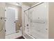 Well-lit bathroom with a tub, shower, toilet, and a white door leading outside at 19281 E Hinsdale Ln, Centennial, CO 80016