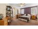 Bedroom with desk, shelves, and a bed, plus a connecting bathroom with a shower at 19281 E Hinsdale Ln, Centennial, CO 80016