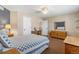 Spacious bedroom with neutral walls, a ceiling fan, and carpet, featuring a desk and a large window at 19281 E Hinsdale Ln, Centennial, CO 80016