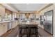 Bright kitchen features a large island with seating and modern stainless steel appliances at 19281 E Hinsdale Ln, Centennial, CO 80016