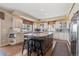 Spacious kitchen featuring an island with seating, granite countertops, and stainless steel appliances at 19281 E Hinsdale Ln, Centennial, CO 80016