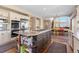 Open kitchen with stainless appliances, granite counters, breakfast bar, and views to the dining area at 19281 E Hinsdale Ln, Centennial, CO 80016
