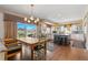Open kitchen and dining area with modern appliances, granite countertops, and hardwood floors at 19281 E Hinsdale Ln, Centennial, CO 80016