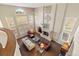 Open living room with fireplace, floor to ceiling windows, and lots of natural light at 19281 E Hinsdale Ln, Centennial, CO 80016