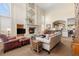 Spacious living room with a stone fireplace, comfortable seating, and lots of natural light at 19281 E Hinsdale Ln, Centennial, CO 80016
