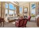 Bright living room with large windows, a fireplace, neutral colors, and comfortable seating at 19281 E Hinsdale Ln, Centennial, CO 80016