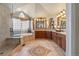 Expansive main bathroom with soaking tub, walk-in shower, dual sinks, and decorative tile flooring at 19281 E Hinsdale Ln, Centennial, CO 80016