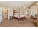 Lovely main bedroom boasts four poster bed, sitting area and an ensuite bathroom with a soaking tub at 19281 E Hinsdale Ln, Centennial, CO 80016
