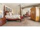Spacious main bedroom featuring a four poster bed, sitting area, and an ensuite bathroom at 19281 E Hinsdale Ln, Centennial, CO 80016