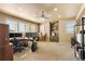 Large office space with carpet flooring, natural light, and built-in shelving for storage at 19281 E Hinsdale Ln, Centennial, CO 80016