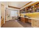 Dedicated home office with built-in bookshelves, a large desk, and ample natural light at 19281 E Hinsdale Ln, Centennial, CO 80016