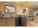 Basement wet bar with granite counters, stone accents, mini fridge and accent lighting at 19281 E Hinsdale Ln, Centennial, CO 80016